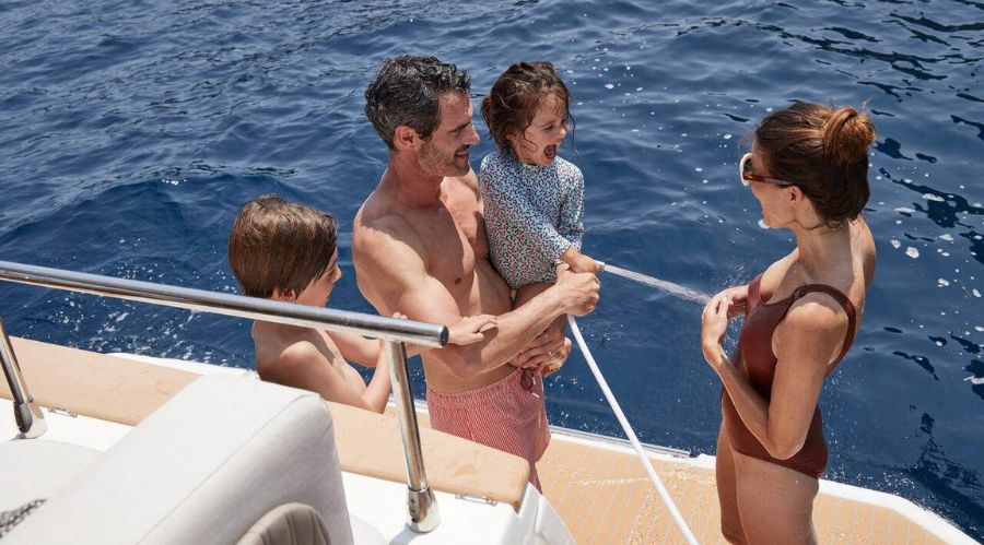 a family on the swim platform of the Prestige F4 yacht